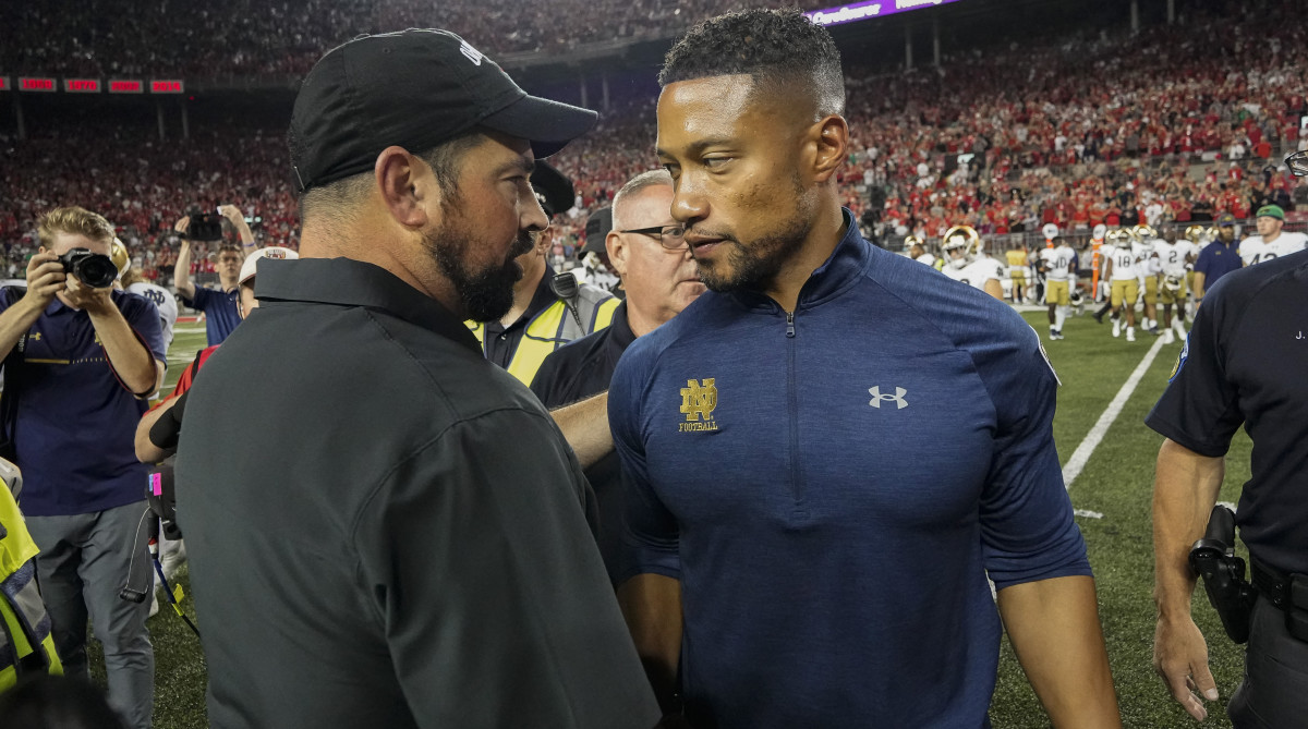 Ohio State coach Ryan Day shakes hands with Notre Dame coach Marcus Freeman.